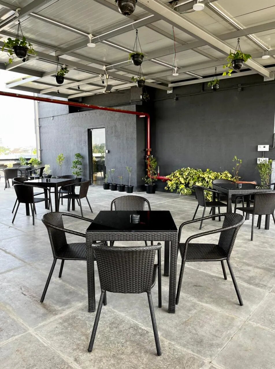 Outdoor cafe seating surrounded by greenery