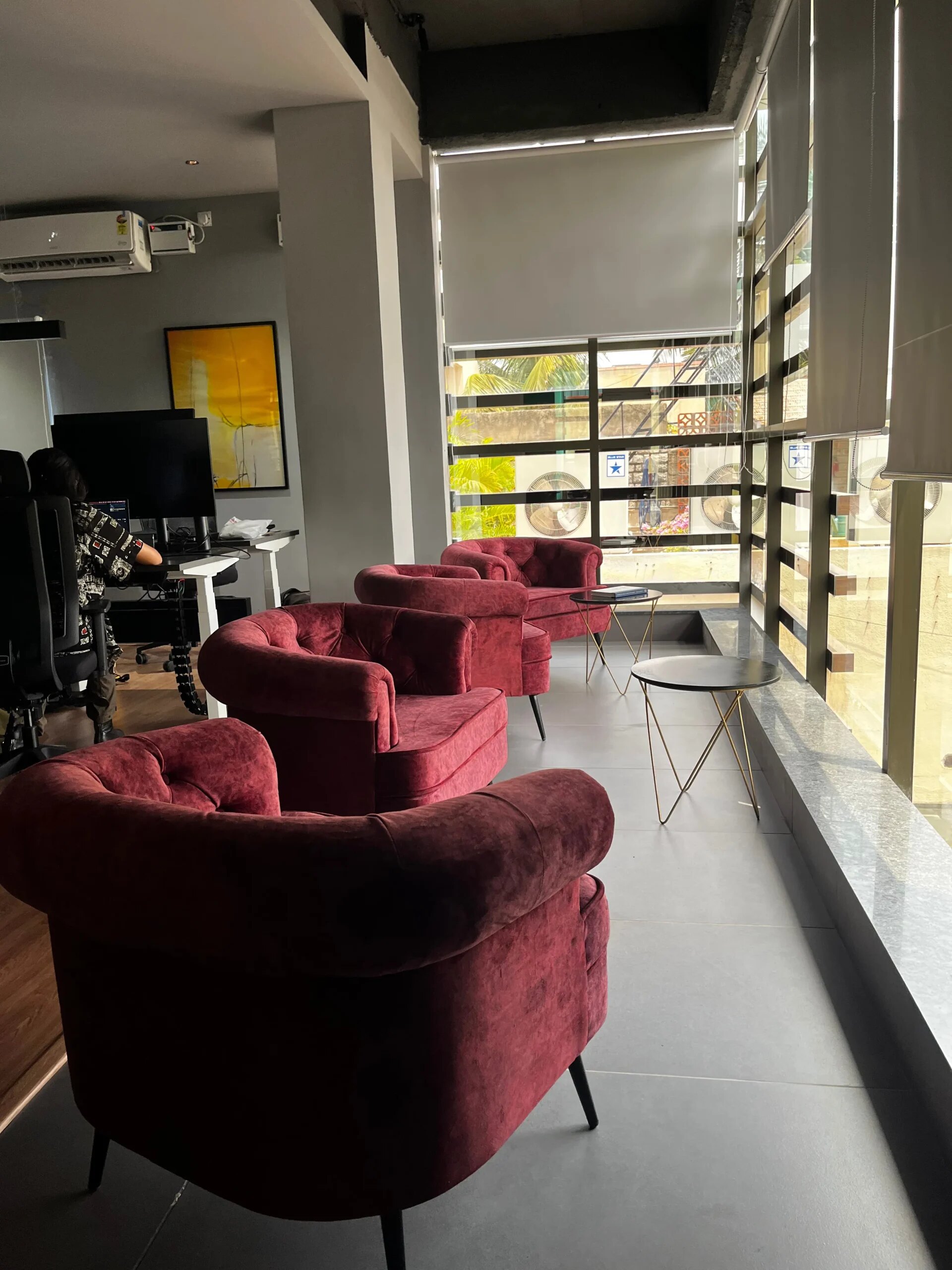 A velvet lounge seating area beside a planted screen at Dongle Desk